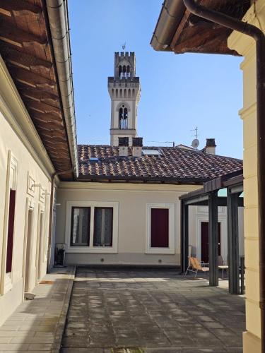 a building with a clock tower in the distance at Camere AL Borgo in Santa Sofia