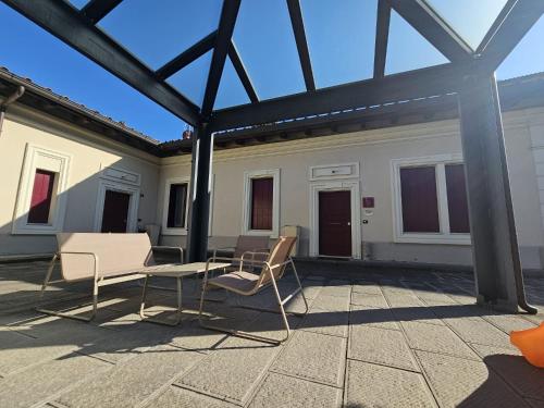 a group of chairs and a table on a patio at Camere AL Borgo in Santa Sofia