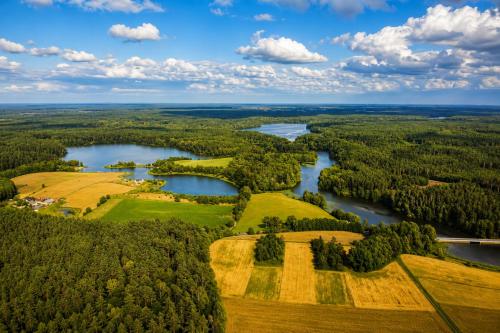 an aerial view of a river and farmland at Apartamenty Dworzec Tleń in Tleń