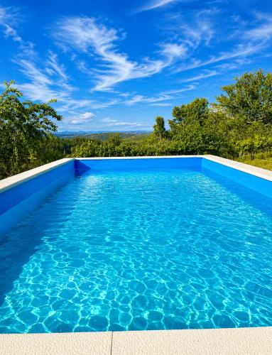a blue swimming pool with a blue sky at Casa dos Invernos in Paçô