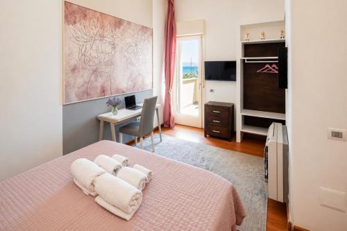 a bedroom with a pink bed and a desk at Villa Maria Luisa in Cagliari
