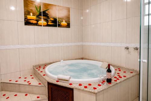 a bathroom with a tub with red hearts around it at Pousada Portal da Serra in Campos do Jordão