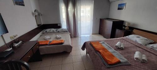 a hotel room with two beds and a desk at Apartment Sansimon in Izola