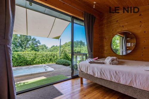 a bedroom with a bed and a tub outside at Les Gîtes Ar Milin in Cordemais