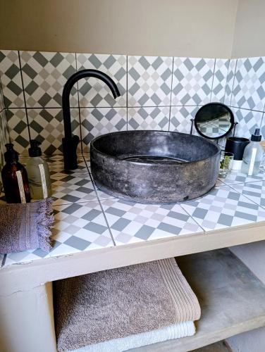 a bathroom sink with a large metal tub on a counter at Exhale Cottage in Montagu