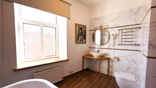a bathroom with a sink and a mirror at White Palace in Riga