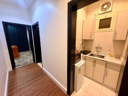 a small kitchen with a sink and a counter at Milestone Rise Jeddah in Jeddah