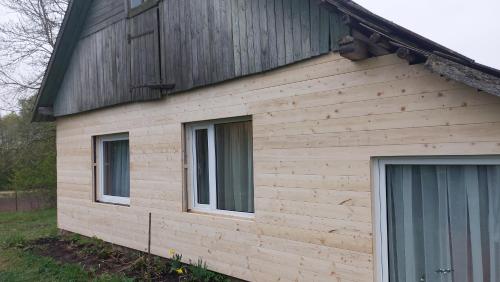 a house with two windows on the side of it at Marija in Krāslava