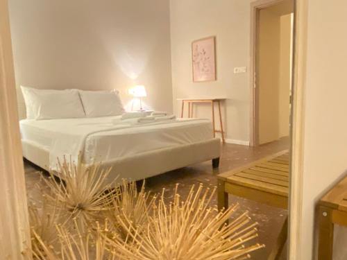 a bedroom with a bed and a table with a lamp at 70 sqm sea view apartment in Parga