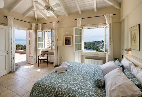 a bedroom with a bed with a view of the ocean at Andromeda Villa in Tranakatika