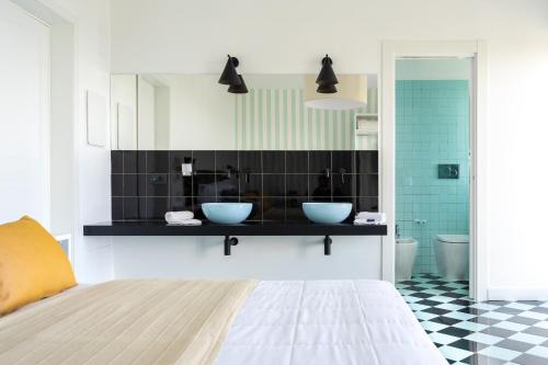 a bathroom with two blue bowls on the counter at Vanity Suite in Sorrento