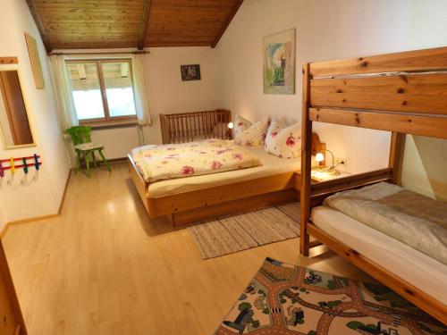 a bedroom with two beds and a bunk bed at Sohlerhof in Eichenberg