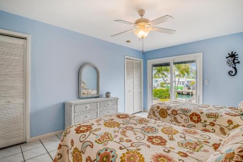 a bedroom with a bed and a ceiling fan at BC277FLR Sapphire Sabbatical in Key West