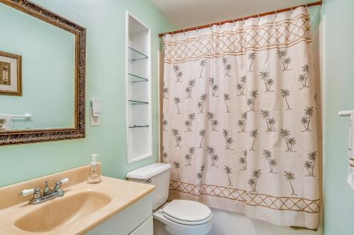 a bathroom with a sink and a toilet and a shower curtain at BC277FLR Sapphire Sabbatical in Key West