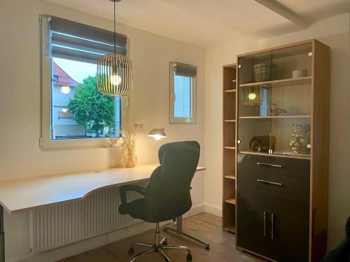 a office with a desk and a chair and a window at Apartment Hornberg-Melisa in Hornberg