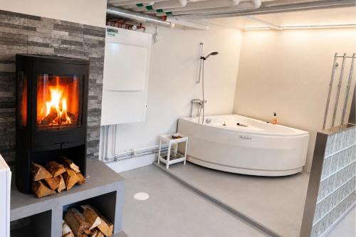 a bathroom with a fireplace and a bath tub at Boende i Vimmerby in Vimmerby