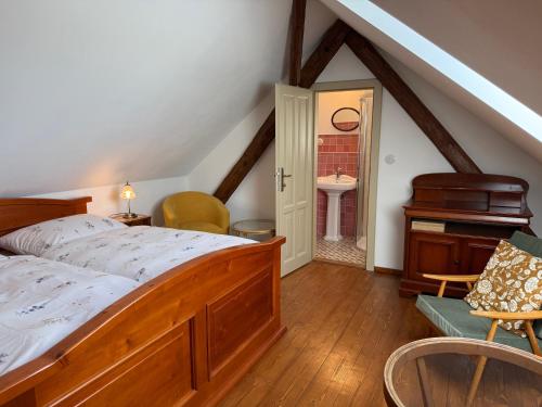 a bedroom with a bed and a sink and a piano at Chalupa na Brdech in Obecnice