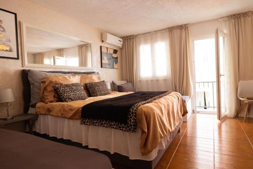 a bedroom with a bed and a large window at Guesthouse Rebecca in Makarska