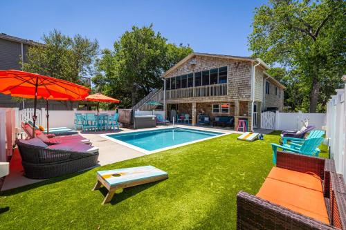 a backyard with a swimming pool and a house at This Home Has It All Location Amenities & More in Duck