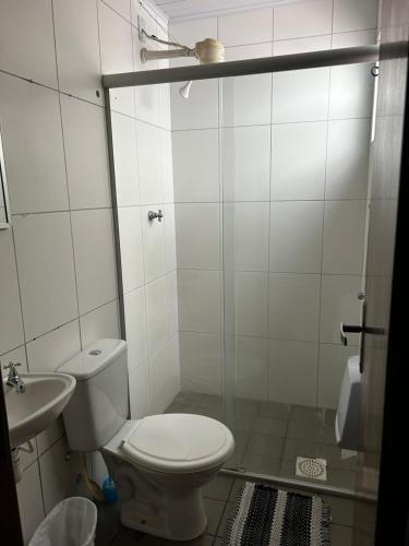 a bathroom with a toilet and a sink at HL Hotel in Pelotas