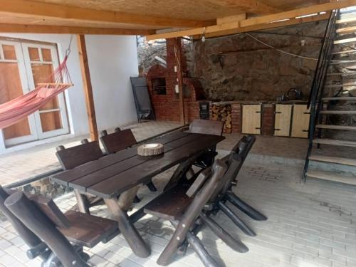 a wooden table and chairs in a room at Casa de vacanță la Dunăre in Sviniţa