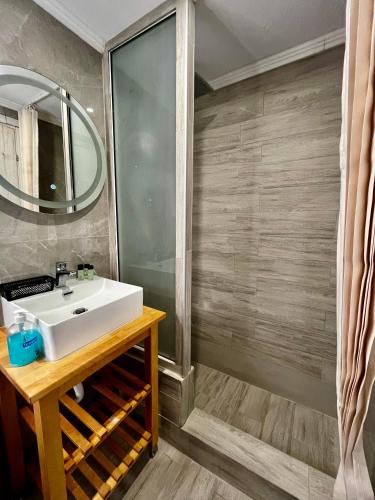 a bathroom with a sink and a mirror at Anthis Studios in Pythagoreio
