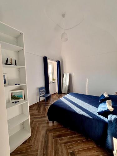 a bedroom with a bed and a book shelf at Da Feny in Massa Lubrense