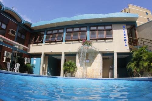 um hotel com piscina em frente a um edifício em Amuarama Hotel em Fortaleza