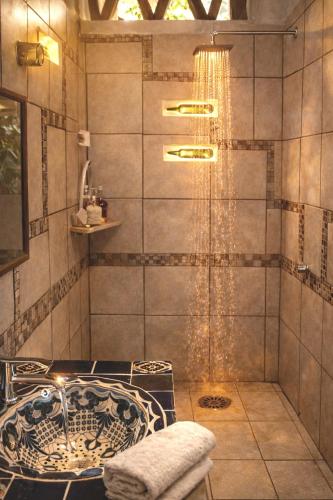 a bathroom with a shower with a glass door at Beachfront - Private Floor, 4 Rooms - Casa 3 Lunas in Playa Agua Blanca