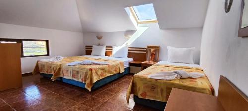 a bedroom with two beds and a window at Хостел Бреза in Sunny Beach
