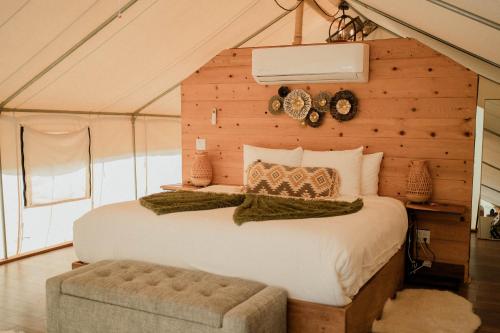 a bedroom with a large bed in a tent at Casa Misiones Glamping in Valle de Guadalupe