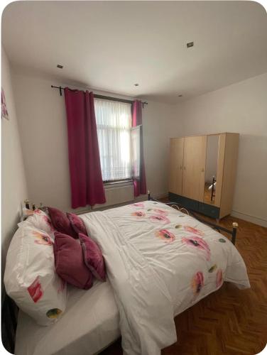 a bedroom with a large bed with flowers on it at Grace Family Home in Brussels