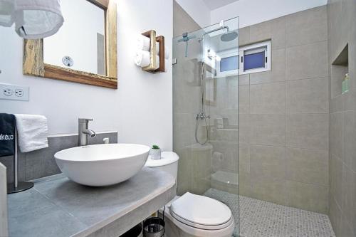 a bathroom with a sink and a toilet and a shower at SUNRISE Heated Pool Ocean View Walk to beach in La Ventana