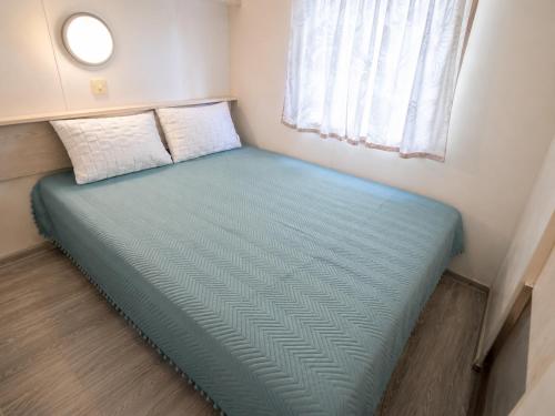 a bed in a small room with a window at Agroktima Arta - Farm Stay in Arta