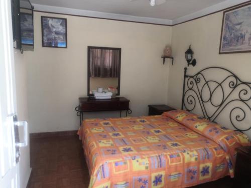 a bedroom with a bed and a sink and a mirror at Arisa in Oaxaca City