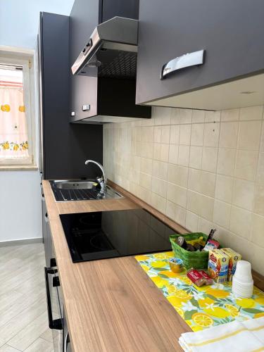 a kitchen with a sink and a counter top at B&B Mamie in Bellizzi