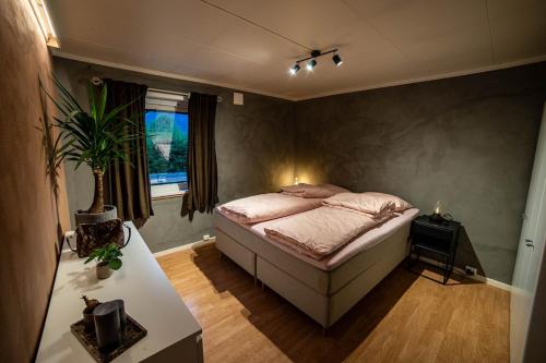 a bedroom with a bed and a table and a window at Cosy house in Ringebu kommune in Ringebu