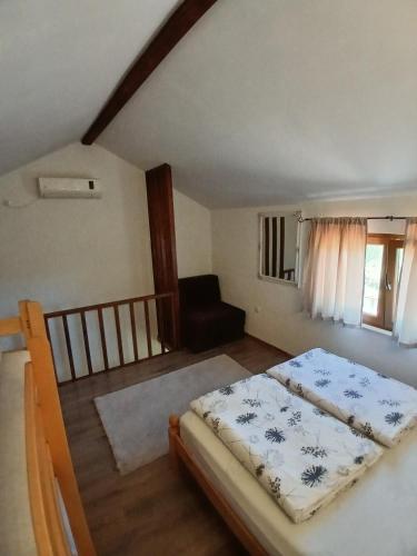 a bedroom with a bed and a couch at Kuća za odmor Buk in Čapljina