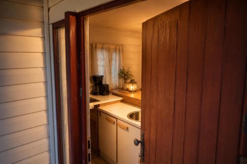 a small kitchen with a sink and a counter at Tiny house met Coldtub 4pers The Firefly in Amblève