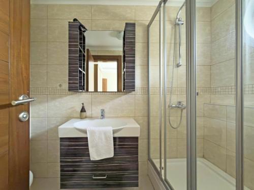 a bathroom with a sink and a shower and a mirror at Paradise Town Villa Marina in Belek