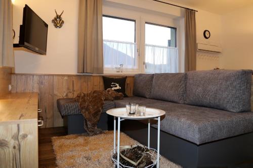 a living room with a couch and a table at Apart Gaberhof in Tarrenz