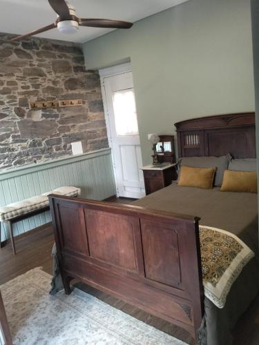 a bedroom with a bed and a stone wall at Refúgio no Douro in Nogueira