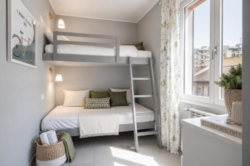 a small bedroom with bunk beds and a window at Beach apartment in the center in Sanremo