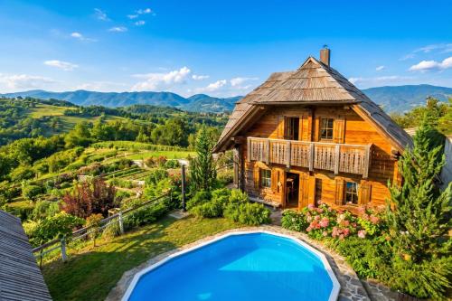 an image of a house with a pool in front of it at Mountain Chalet Podgorje with Pool - Happy Rentals in Slovenj Gradec