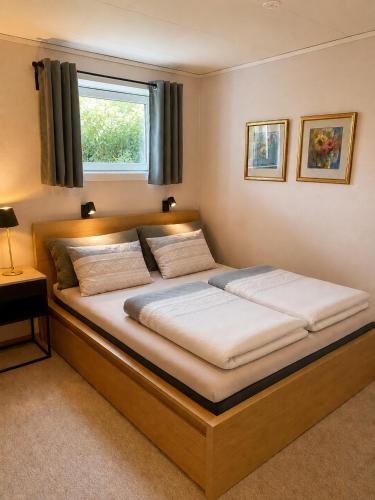 a large bed in a room with a window at Apartment Mandal in Mandal