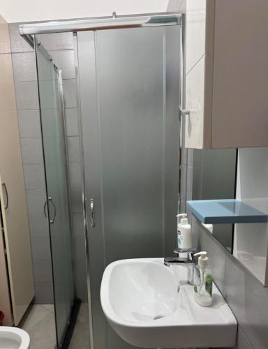 a bathroom with a sink and a shower at Sea view Appartment in Shëngjin