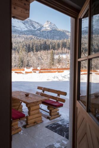 a table and bench in a room with a window at Haus Alpenblick Lofer in Lofer