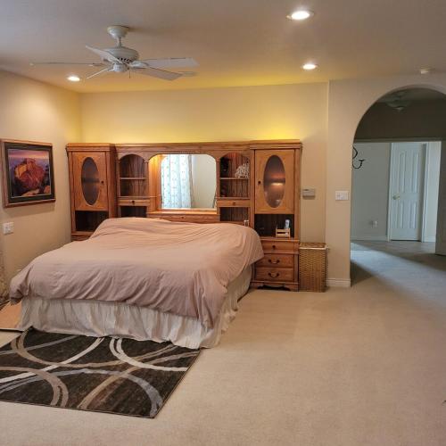a bedroom with a large bed and a ceiling fan at Monument Resort in Grand Junction