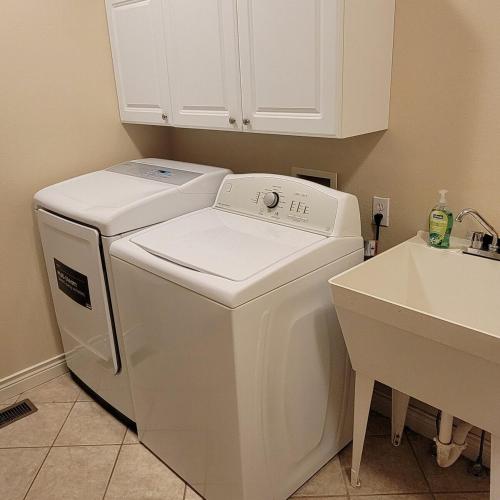 a white washer and dryer in a kitchen next to a sink at Monument Resort in Grand Junction