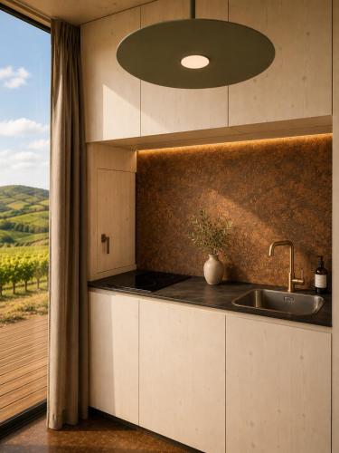 a kitchen with a sink and a counter with a window at Glamping Domik Tokaj in Malá Tŕňa